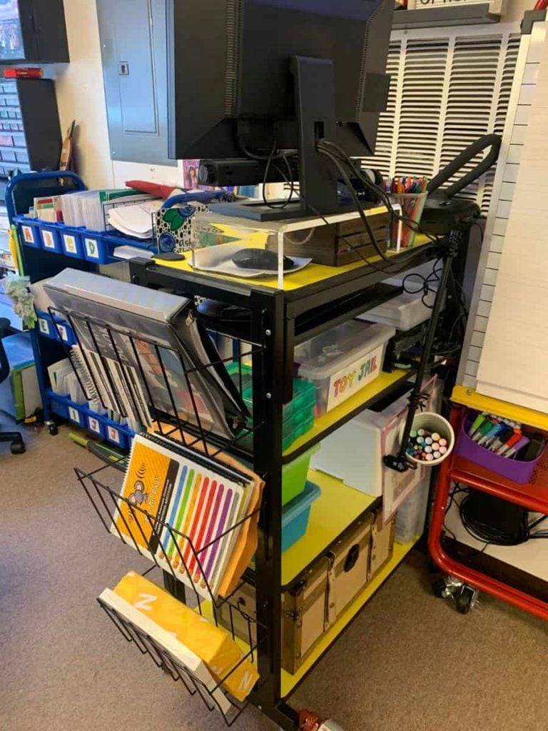 standing desk with baskets on the side for teacher materials